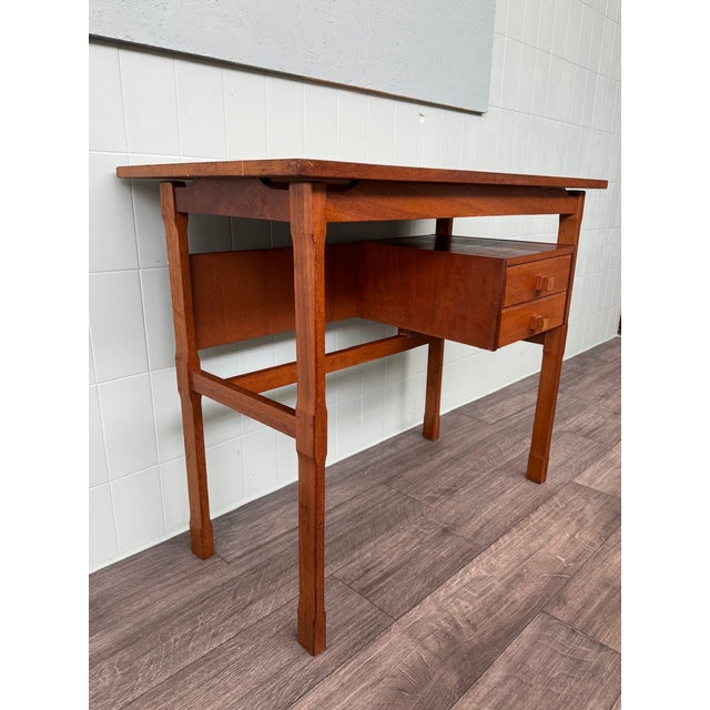 Scandinavian-made desk from the 1950s. Made entirely of teak. It features a double drawer with wooden knobs.