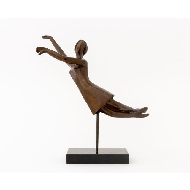 Tanya Poust (American, XX) Stylized Female Figure Patinated Bronze Sculpture, floating atop a stem above a black marble...