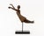 Tanya Poust (American, XX) Stylized Female Figure Patinated Bronze Sculpture, floating atop a stem above a black marble...
