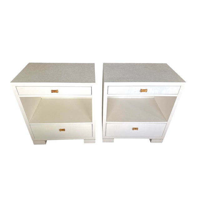Pair of white lacquered linen wrapped Grasscloth nighstands. Custom Bamboo pulls. Top drawer and large bottom drawer....