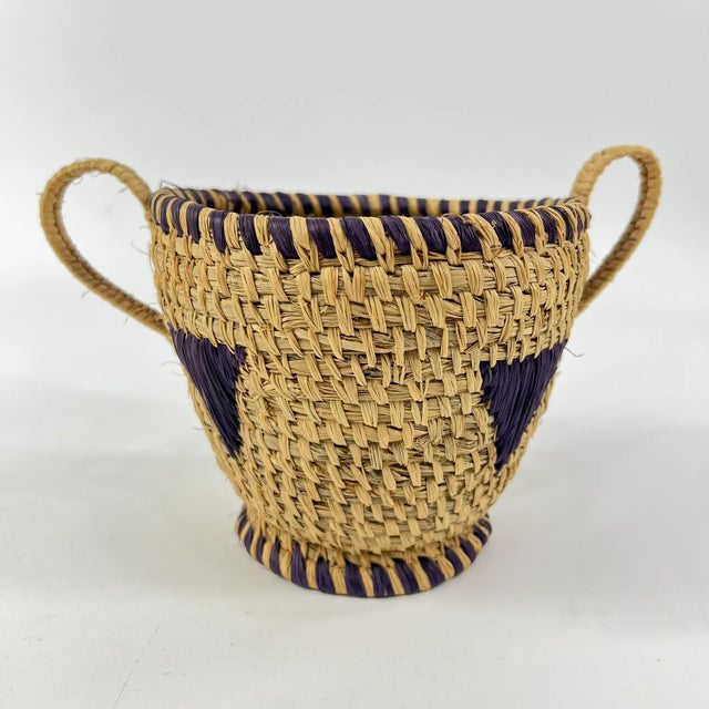 This vintage handmade basket, crafted by the Hausa people of Northern Nigeria, is an exquisite example of traditional...