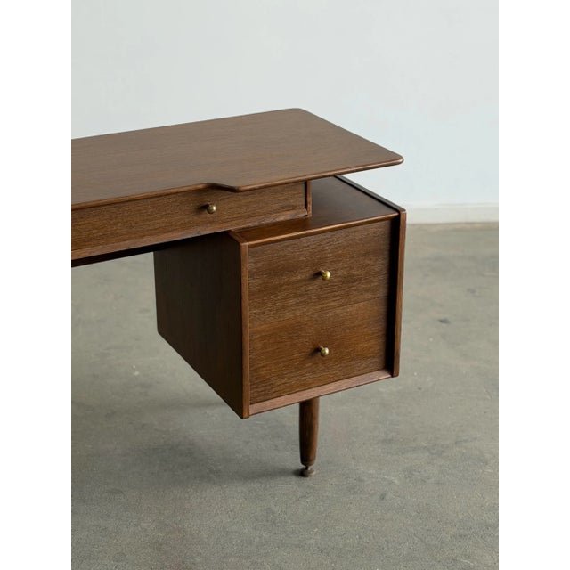 W49 D18 H29.25 Knee Clearance 24.5 KW16 Authentic vintage G-Plan desk by E. Gomme Ltd., made in England circa 1960s....