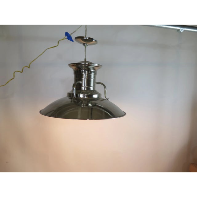 Large vintage style farmhouse steel pendant with sleek lines and a bright golden glow. I found this light at Liz's...