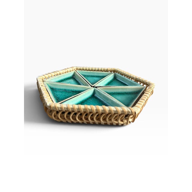 Striking vintage serving piece combining a handwoven rattan tray with six removable triangular ceramic inserts in a rich...