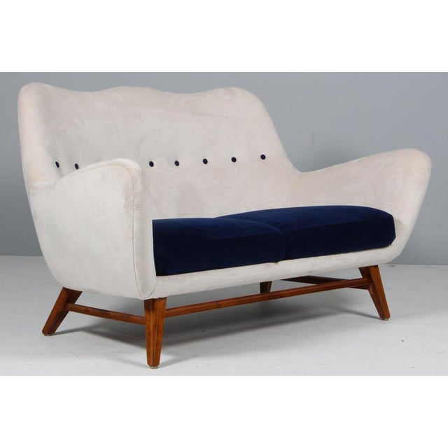 Scandinavian Cabinetmaker two seat sofa of blue and white mohair style fabric. Legs with carved out details. Made in the...