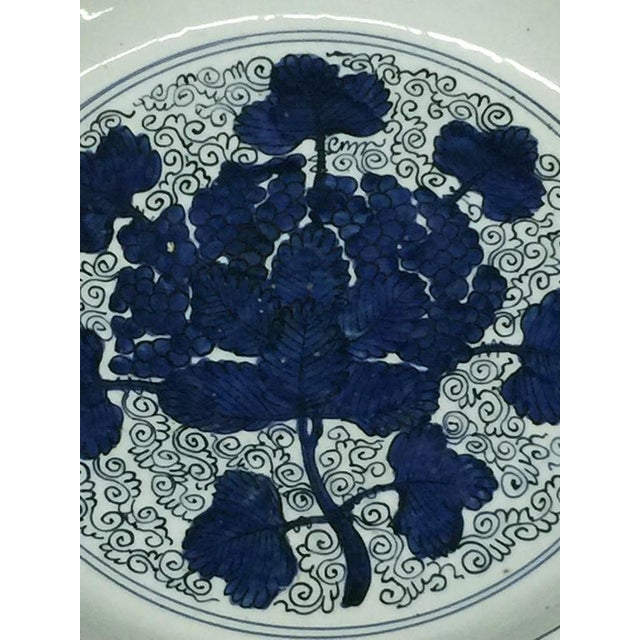 Large blue and white "Grape Dish". Ming dynasty (1368-1644), Jiajing period (1522-1566). The interior is painted in rich...