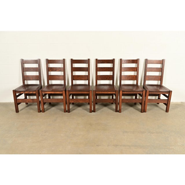 An exceptional set of six antique Mission or Arts & Crafts period solid quarter sawn oak ladder back dining chairs By...