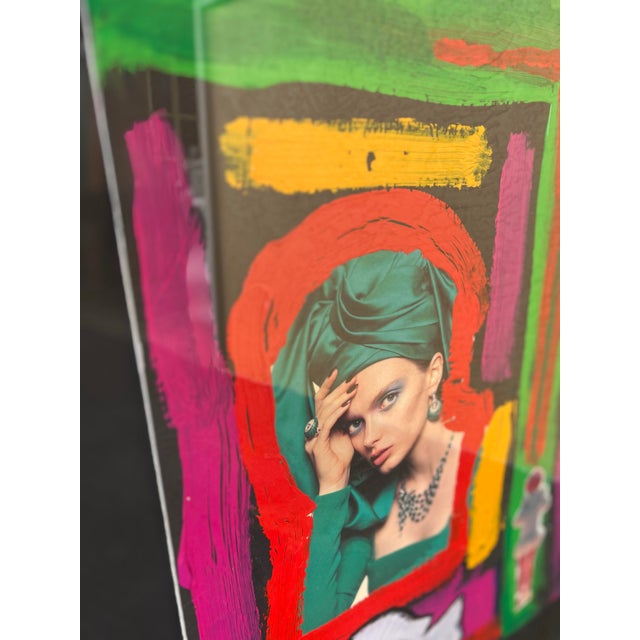 Framed mixed media collage featuring vibrant neon colors, collage elements, and a stylized figure. Gold wood Frame with...