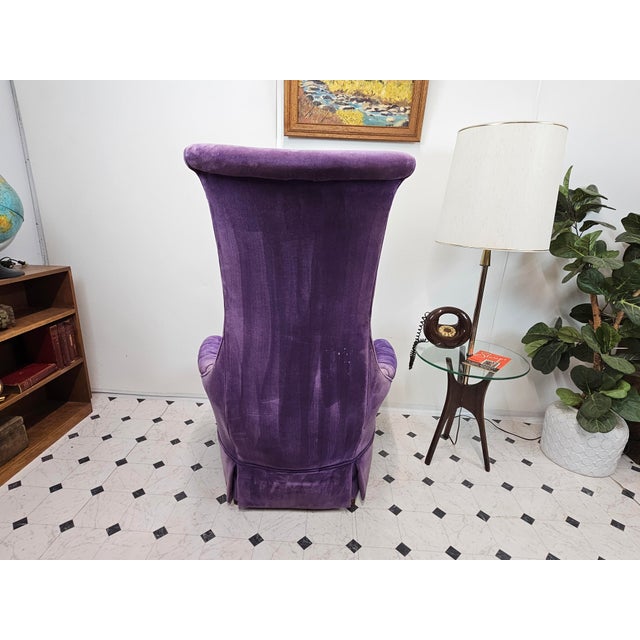A jewel-toned showstopper with an unmistakably regal silhouette. Description: This dramatic high-back chair is upholstered...