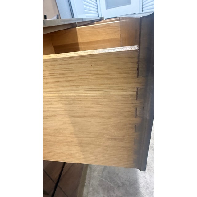 Vintage Mastercraft 9-drawer dresser featuring rich walnut with bookmatched veneer fronts, bold brass framing, and...