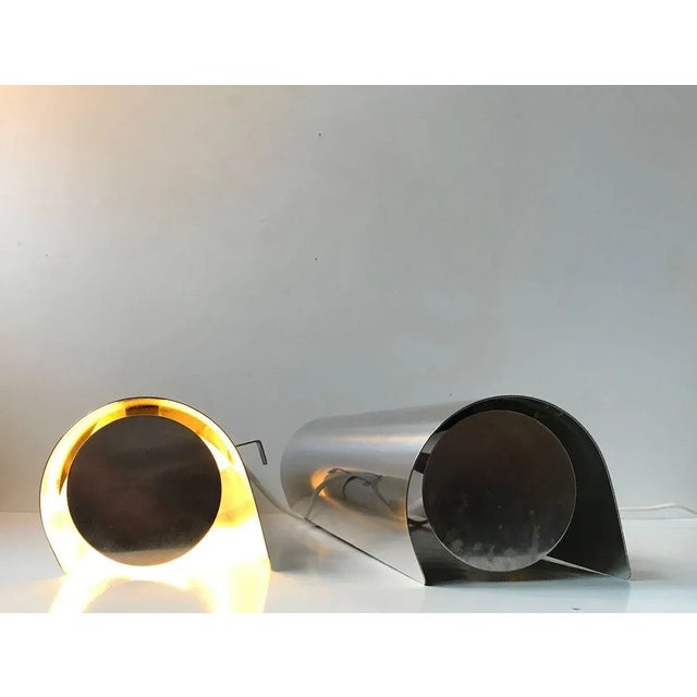 A rare pair of stainless steel wall lights. Cylindrical - tubular in shape and measuring 40 cm in width/length. Designed...