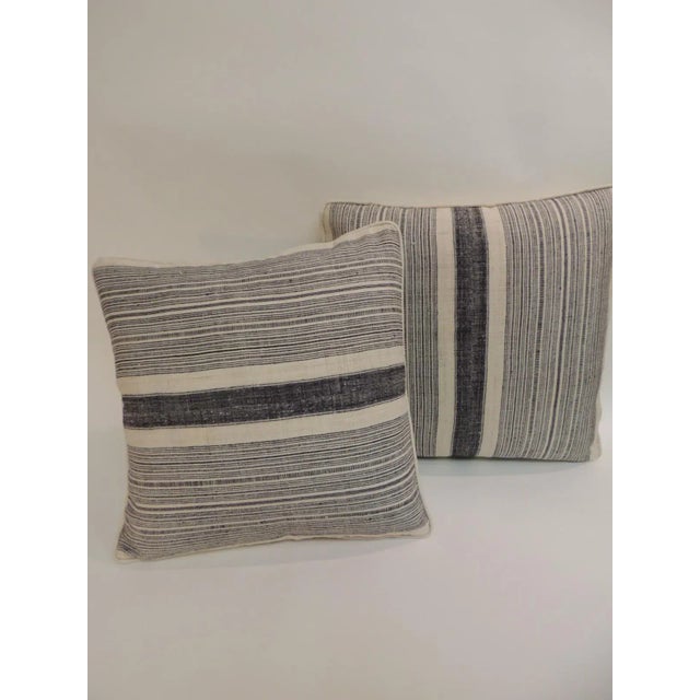 Pair of vintage Chinese Homespun blue and natural stripes decorative pillows. Decorative pillows finished with antique...