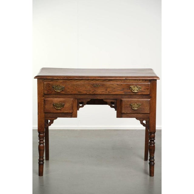This beautiful 18th-century English oak lowboy has a gorgeous patina with lovely details. The lowboy has 3 drawers with...