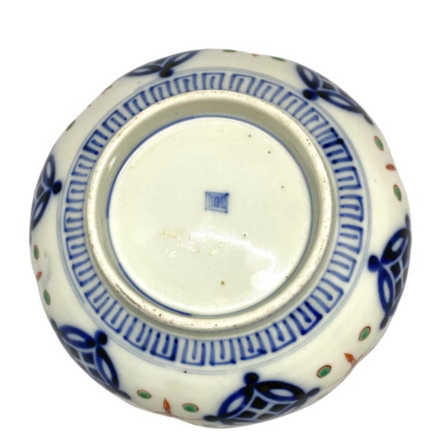 A fine late 19th century Japanese Meiji period lobed bowl. The cobalt blue geometric border surrounds an interior field...