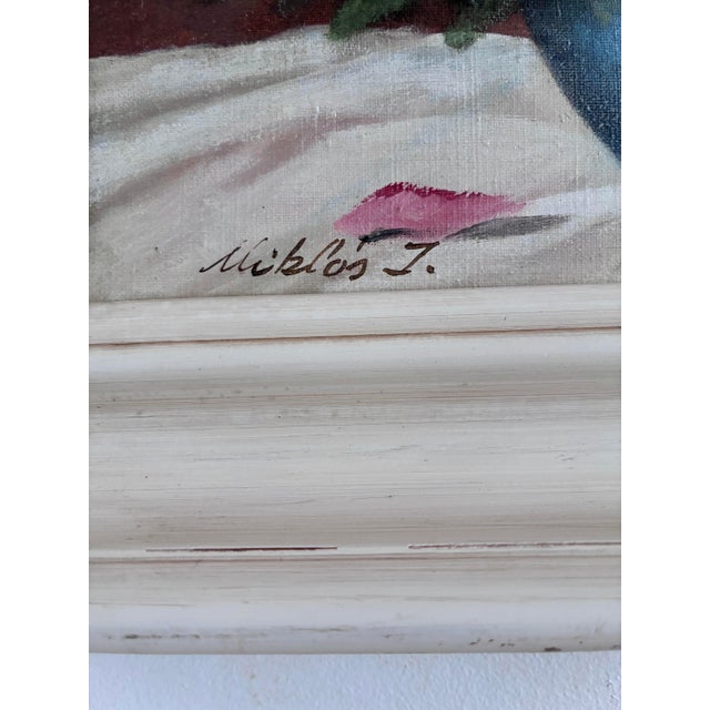This original vintage oil painting from around the 1940s shows a bouquet of roses arranged in a dark blue vase. Pink,...