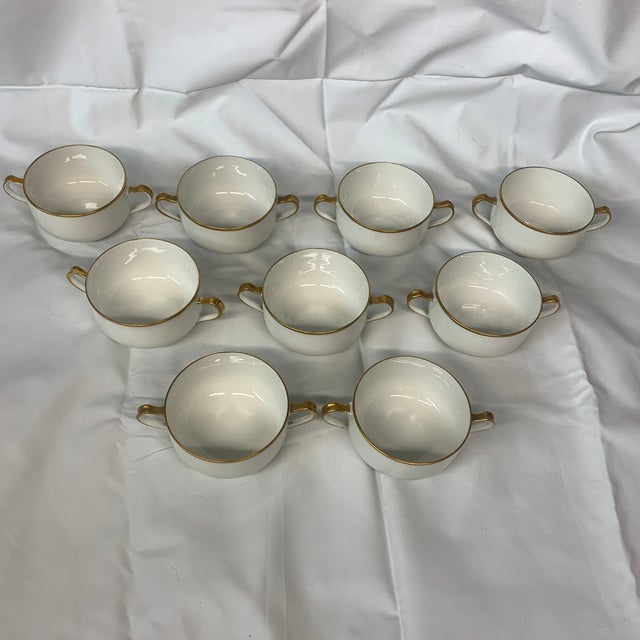 These porcelain double-handled bouillon or cream soup cups feature a classic white body accented with fine gold trim along...