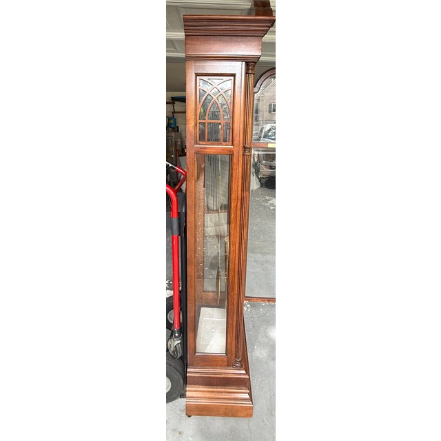 Vintage 1980s Howard Miller grandfather clock, Model 610-352, made in the USA. Features a traditional wood case with...