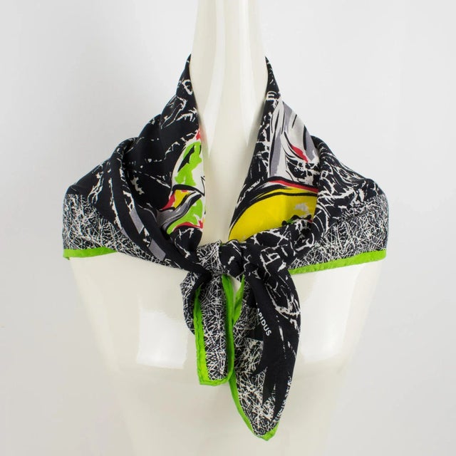 This stylish Ted Lapidus Paris silk scarf features two stylish fashion models' design print in an assorted combination of...