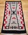 Discover the beauty and craftsmanship of this authentic vintage Navajo rug, handwoven in the Southwestern United States...
