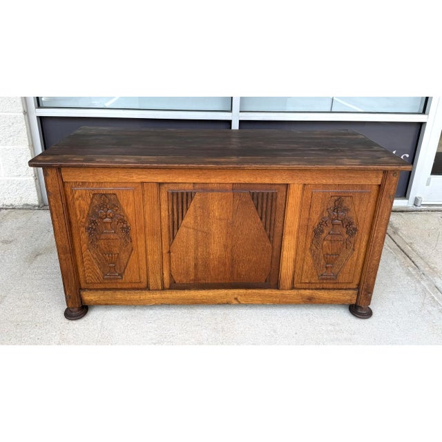 This Antique Belgian Oak Blanket Chest features a warm oak finish with carved urn-and-floral panels, paneled construction,...