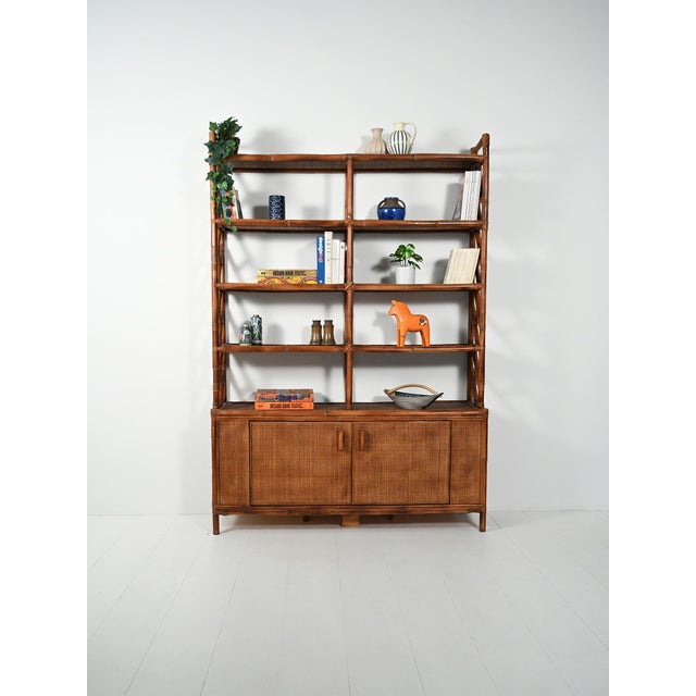 1960s bamboo and rattan bookcase: double-door storage base and upper section with exposed shelves, diamond-shaped woven...