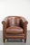 This beautiful cognac-colored English-style cowhide leather club armchair features a comfortable seat, a loose seat...