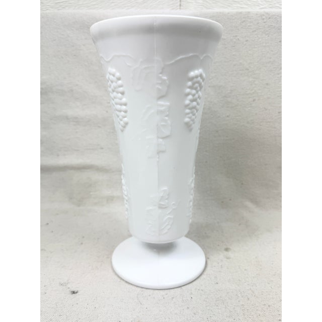 Nice vintage milk glass vase. Features a grape design. Large size. Perfect to add to collection or to use for floral...