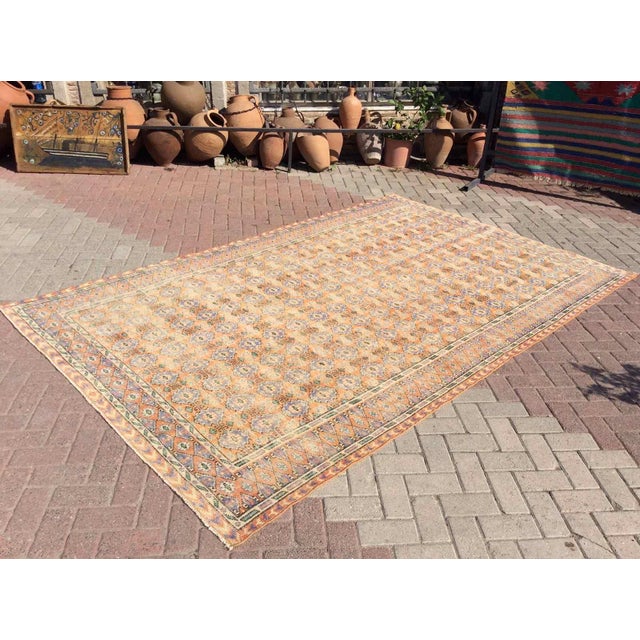 This gorgeous traditional hand knotted Vintage Anatolian area rug is approximately 60 years old in excellent vintage...