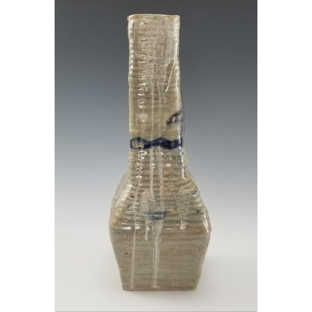 This stunning studio art pottery vase is a unique piece of handmade ceramic. The vase is made of a taupe beige sanded...