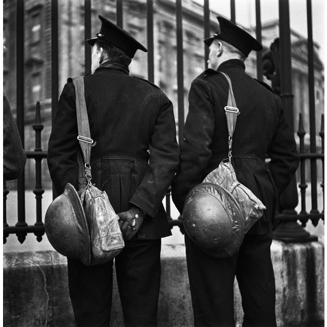 Investiture Day During World War II Two uniformed men at the gates of Buckingham Palace in London on Investiture Day...