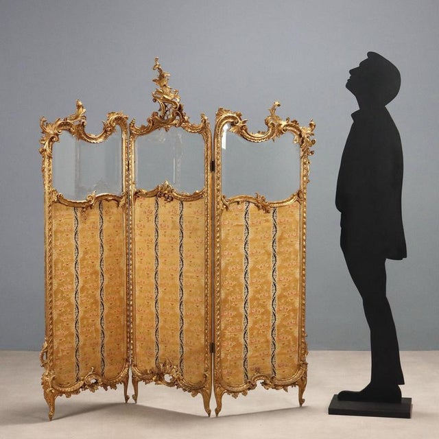 Rococo-style screen in carved and gilded wood. Three elements with a beveled glass top and a wooden panel covered in...