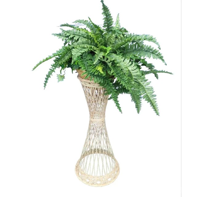 A tall vintage spun fiberglass plant holder stand by Woodard