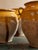 Two-handled French terracotta confit pot with an ochre-yellow glaze over the shoulder and long glaze drips down the...