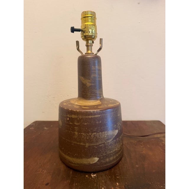 Mid century Gordon and Hane Martz lamp for Marshall Studios. The lamp features a textural earth toned brown glazed...