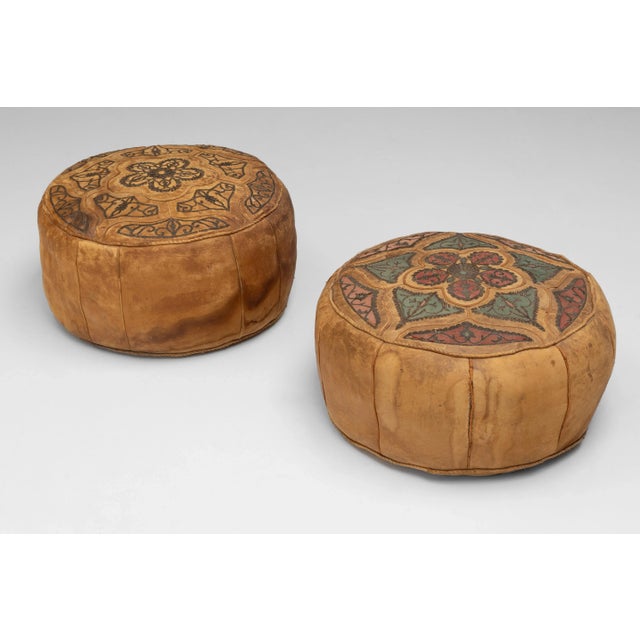 Pair of decorative leather covered pouffes with embroidered decoration. Circa 1930.