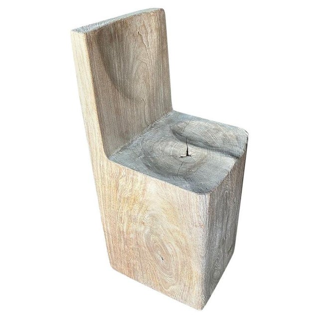 Beautiful chair hand carved from a single reclaimed teak wood block. Both usable and sculptural. We bleached the wood...