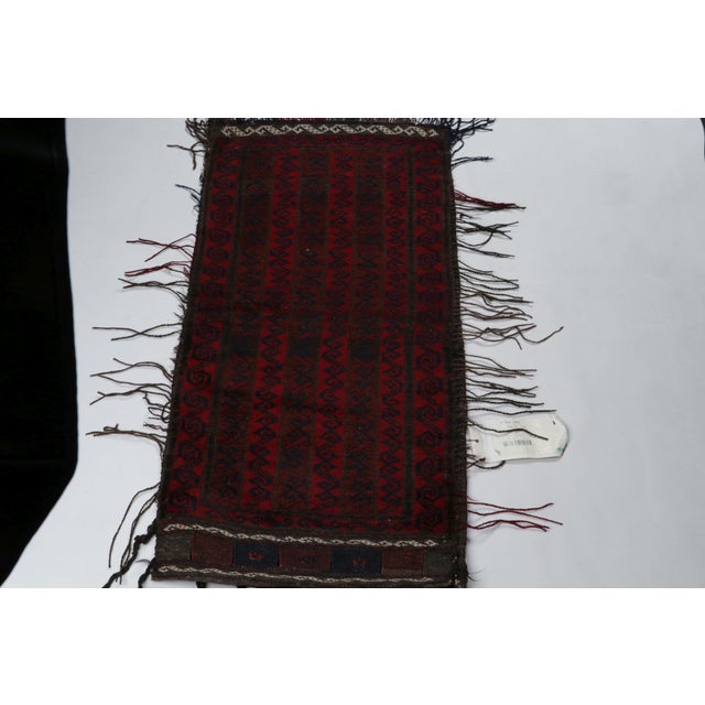 Hand-knotted in wool, this 1x3 Baluch Persian rug of the 1950s is the latest to enter Rug & Kilim’s Antique & Vintage...