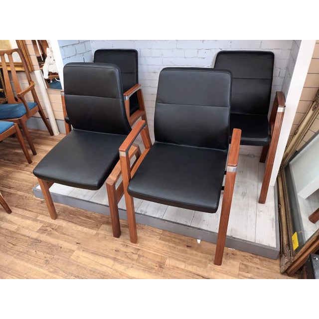 Elevate your interior with this distinguished set of four sven fulcrum leather danish-style stackable dining or reception...