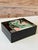 A bold and playful 1980s decorative box featuring a graphic pair of pink flamingos set against a tropical Art...
