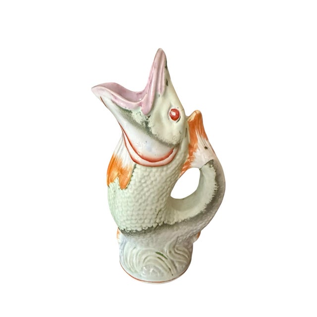 This is an antique Victorian English majolica fish pitcher or vase. It is made from polychrome ceramic and features a...