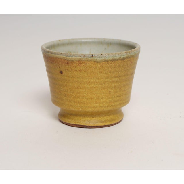 Diminutive stoneware footed vessel/bud vase by ceramicist, Deanna Nichols (b. 1942-2017, Missouri). Holding a BFA from...