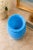 A striking vintage sculptural art glass vase featuring an elegant ribbed swirl design in a vibrant sky-blue hue. Its...