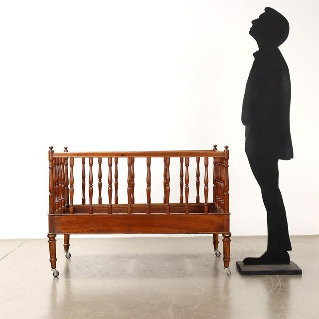 Walnut bed made in the late 19th century, gate structure made with turned walnut columns, turned feet with non-...