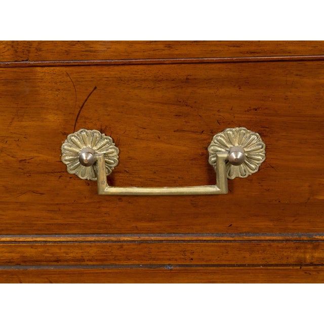A pair of French Neoclassical style walnut commodes from the 19th century, with white marble tops, three drawers, fluted...