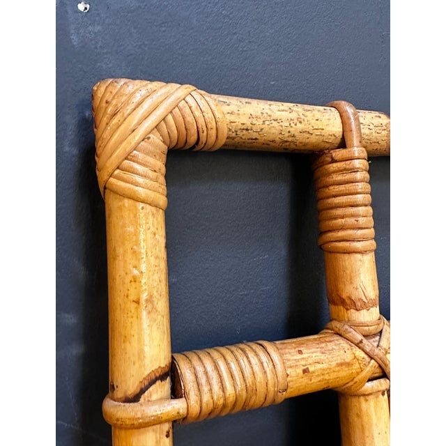 "A vintage Italian square bamboo wall mirror from the 1980s, featuring a natural and rustic design that brings warmth and...