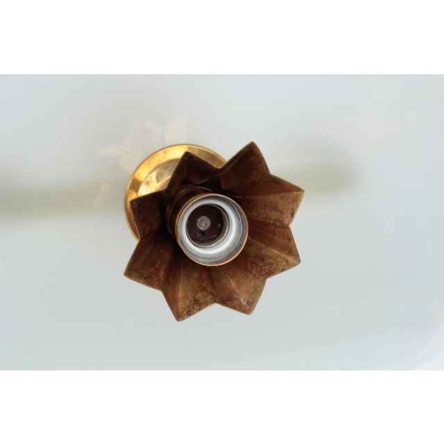 A rare original piece from around 1920. the pendant light consists of a brass body and has a glass pane with a satin...