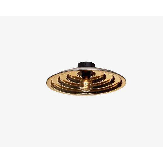 Gold echo ceiling light, small by radar. Design: bastien taillard. Materials: thermoformed gold glass, metal. Dimensions:...