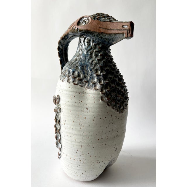 Stoneware ceramic reptilian pitcher created by Jack Mason of Stone Mountain, Georgia. Pitcher measures 14.5" high by 8"...