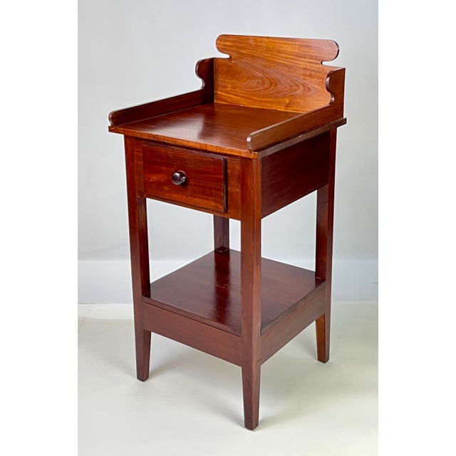 A wonderful example of bench-made country furniture, this antique washstand is crafted from solid mahogany. The piece is...