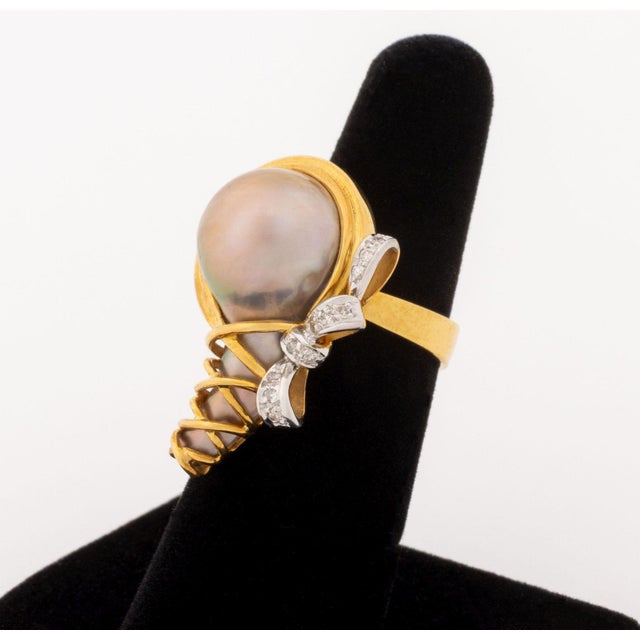 14K Rose and White Gold Diamond Pearl Ring, featuring eleven pave set round brilliant cut diamonds weighing a total of...